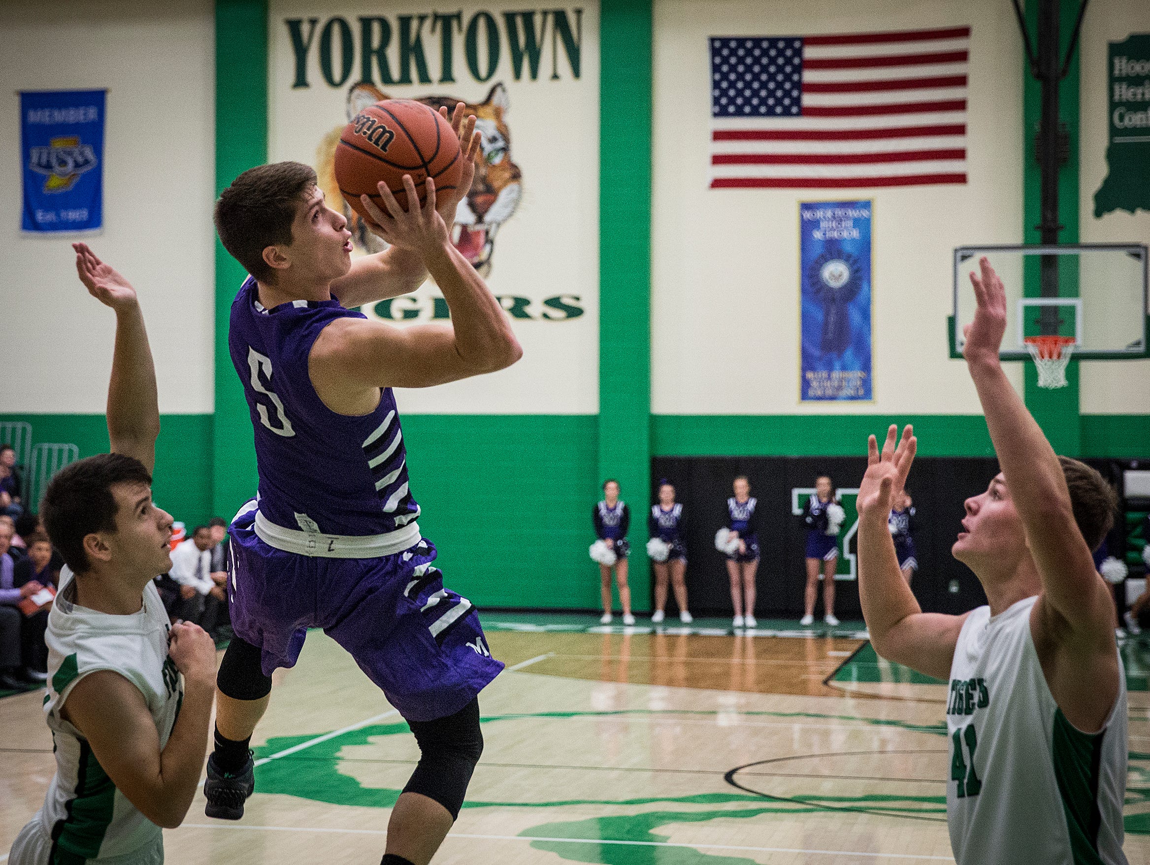 Central's Trenton Hatfield slips past Yorktown's defense during their game at Yorktown High School Saturday, Nov. 28, 2015.