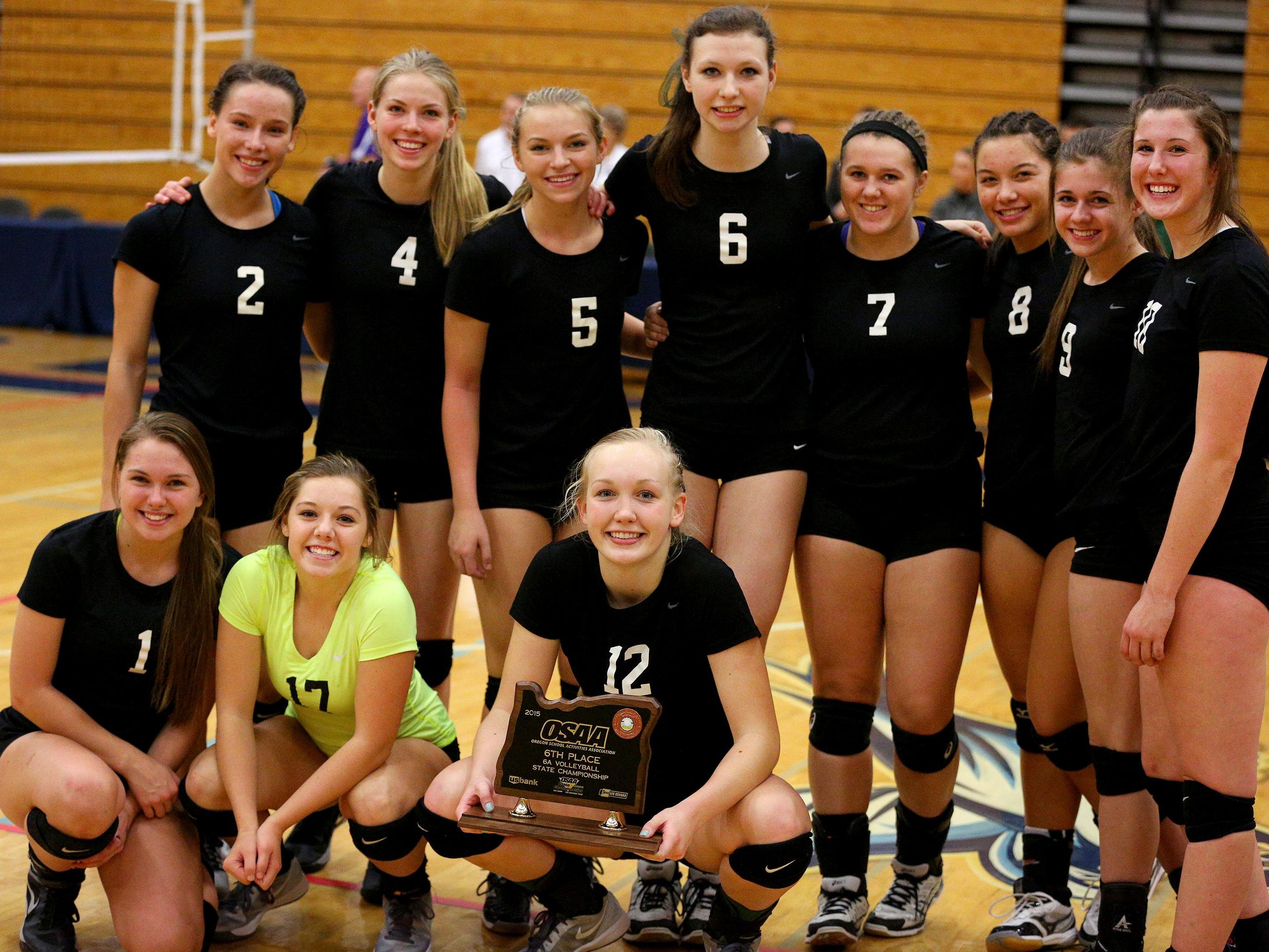 The West Salem volleyball team with their sixth place trophy after losing 3-2 against Sunset during the fourth place gameof the 6A state volleyball playoffs, Saturday, November 7, 2015, at Liberty High School in Hillsboro, Ore.