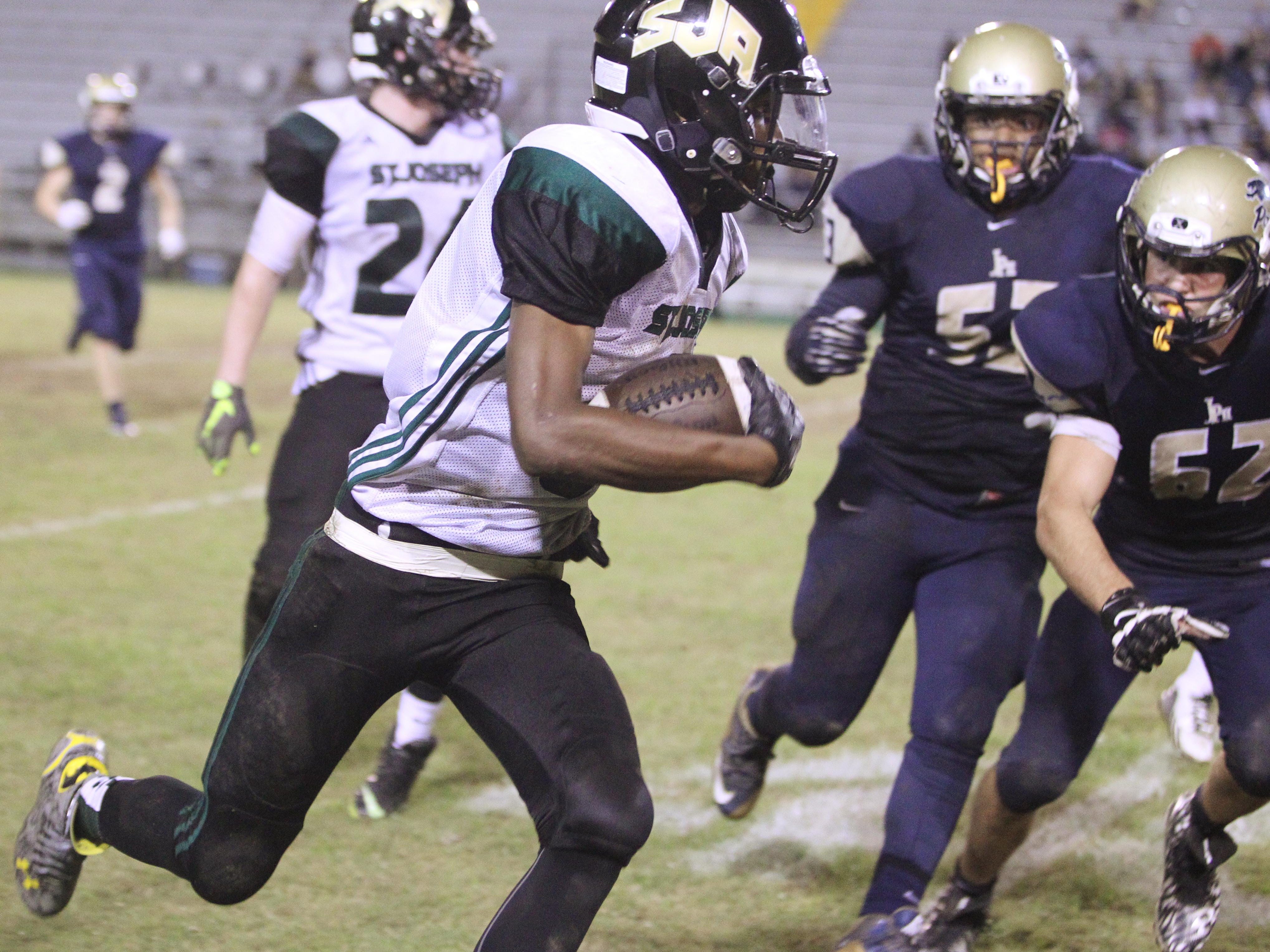 St. Joseph Academy's Tre Preston returns a punt 25 yards to set up a touchdown in the championship game of the North Florida Football Conference at Gene Cox Stadium.