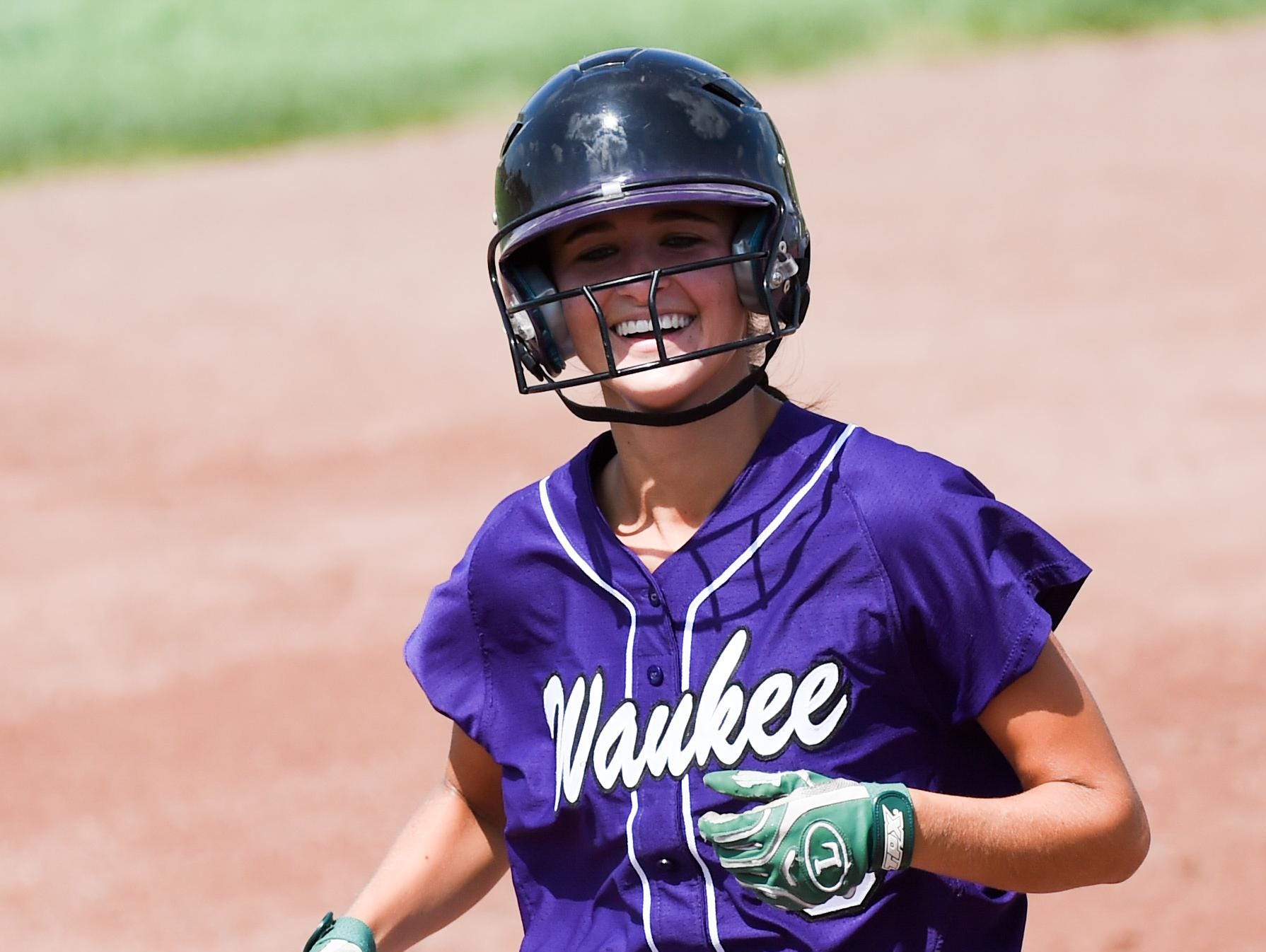 Waukee's Taylor Hulsing (9) smiles as she runs out her two run home run on Thursday, July 23, 2015, during the Class 5-A Semifinals.