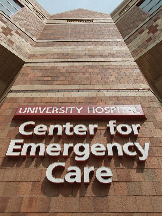 Text: university 2 metro 5/23/96 university hospital er logo. cincinnati enquirer/michael e. keating mek