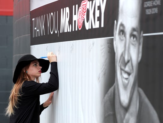 Allison Karczynski, 20, of Livonia, signs a Mr. Hockey