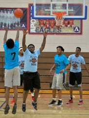 Members of the Originals, in darker blue, play against