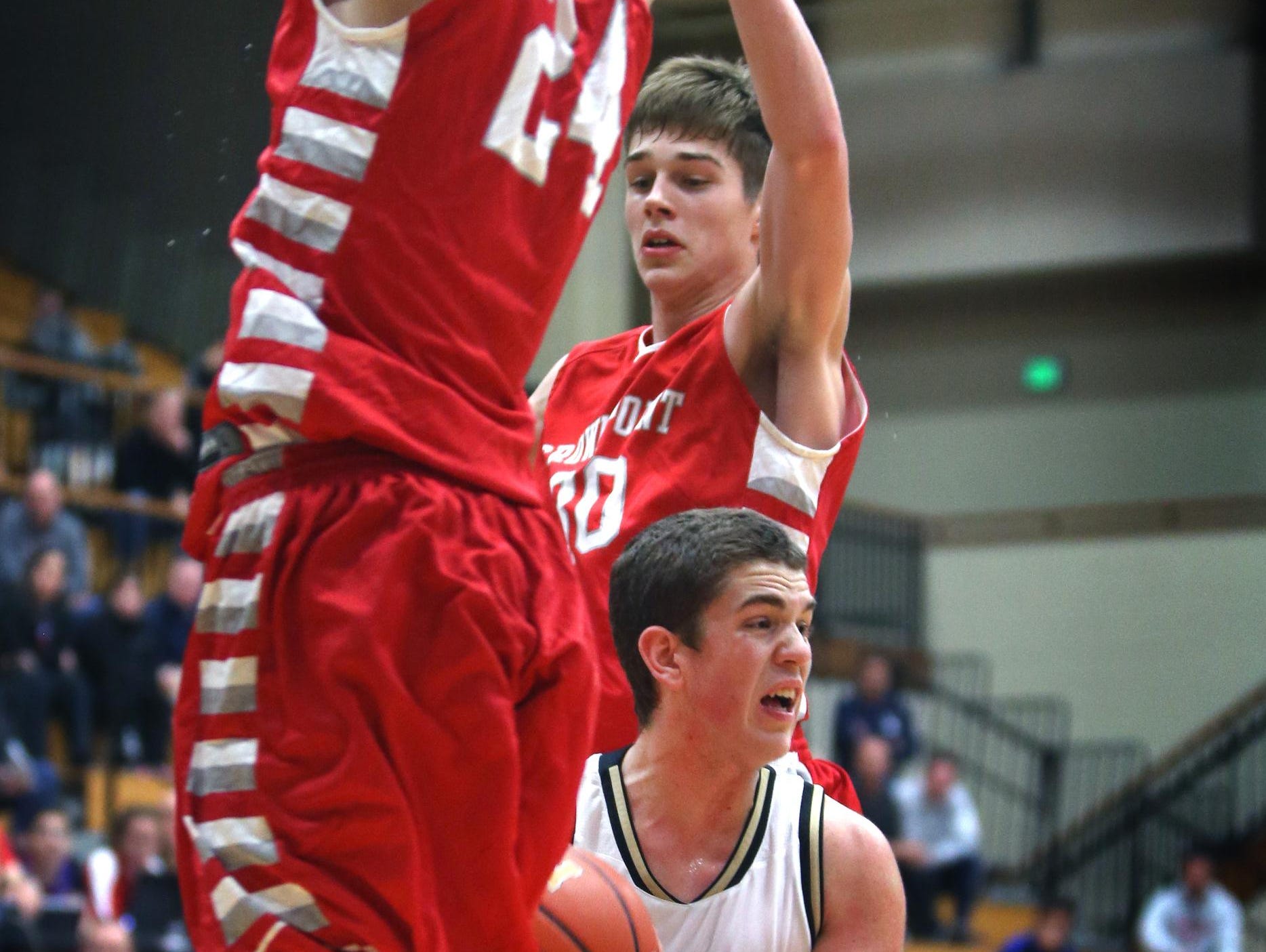 In this Dec. 30, 2014 file photo, Crown Point’s Grant Gelon (right) and teammate Noah Morales defend against Noblesville's Sean Wilson.