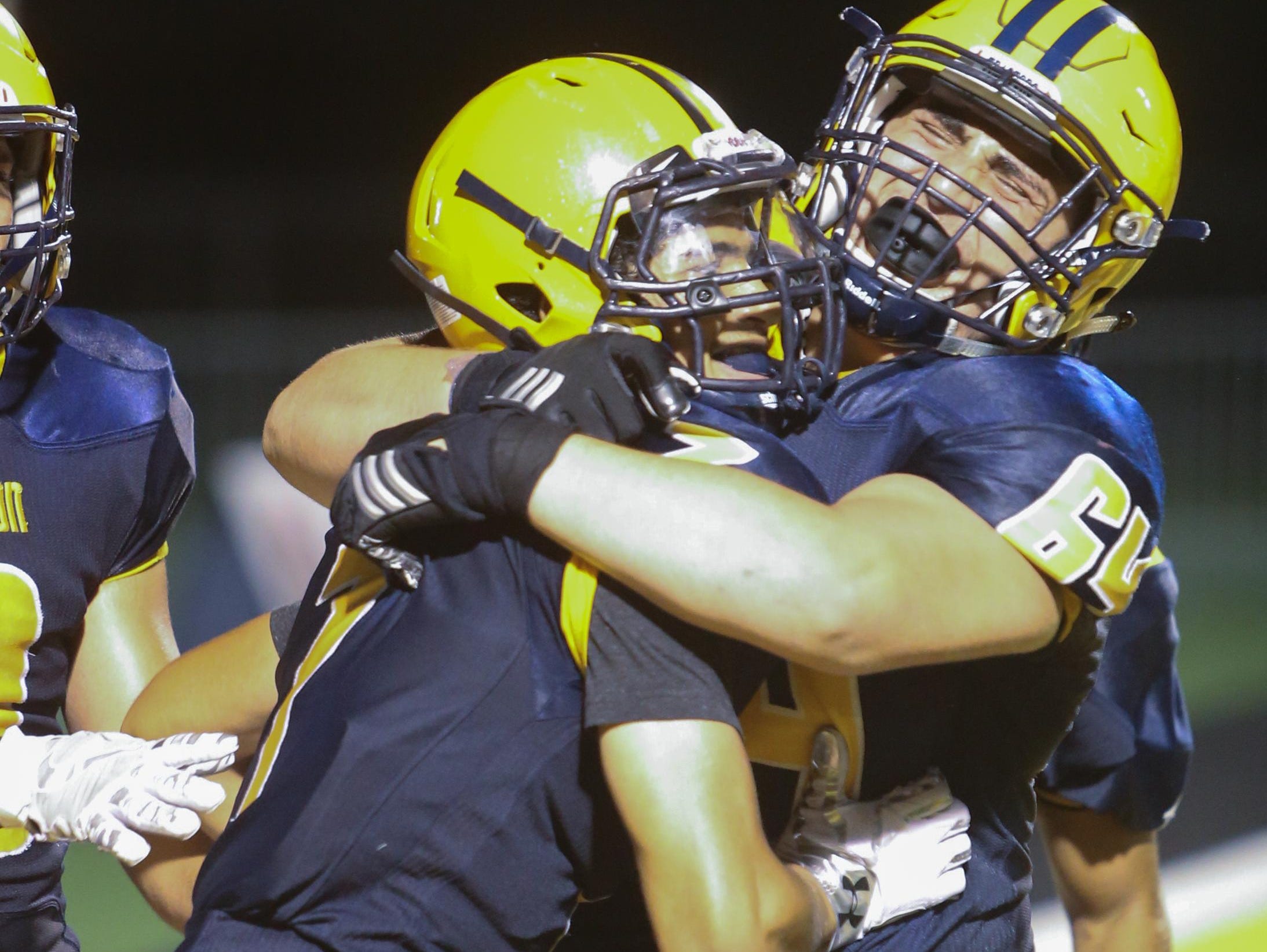 Dearborn Fordson’s Slay Shajrah celebrates his winning TD catch with teammate Mohammed Chami.