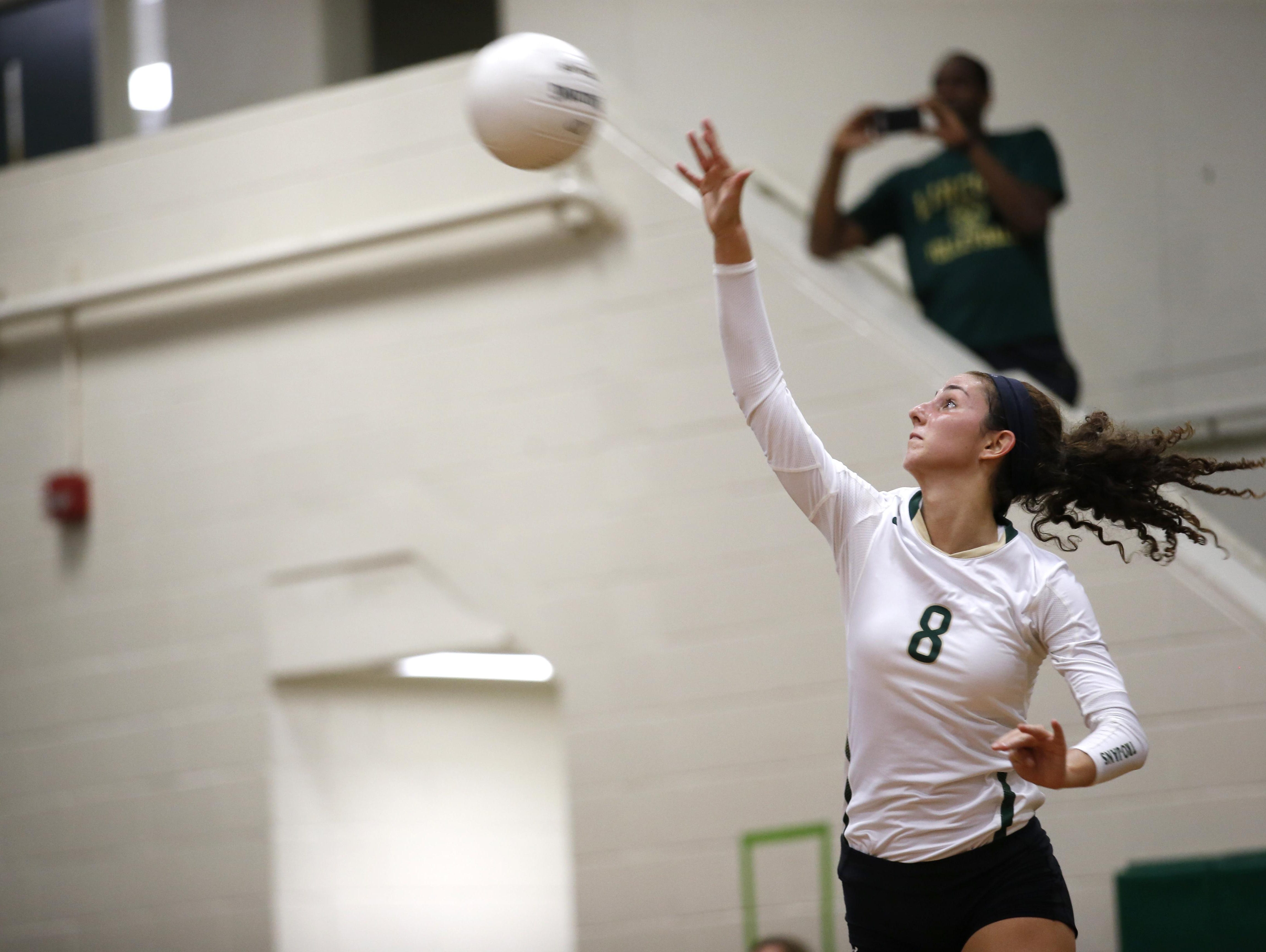 Lincoln junior Madison Fitzpatrick serves during the Trojans’ 3-1 loss to Leon on Tuesday. Fitzpatrick had 13 kills and 16 digs in the match.