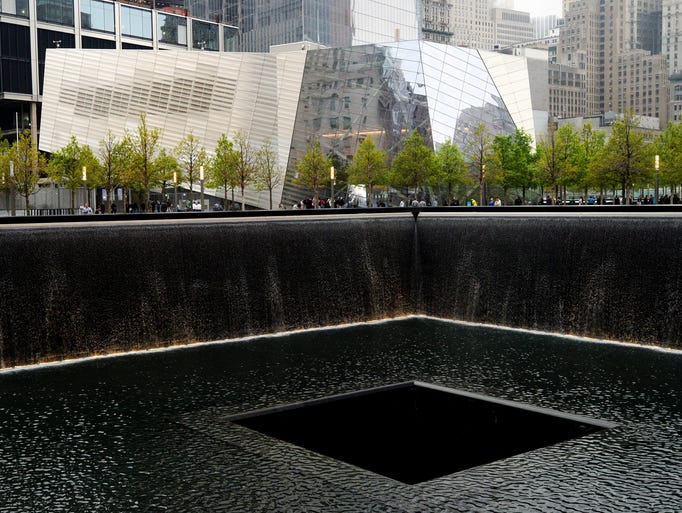 NEW YORK, NY - MAY 15: The National September 11 Memorial Museum stands beyond the north reflecting pool during the opening ceremony for the museum at ground zero May 15, 2014 in New York City. The museum spans seven stories, mostly underground, and contains artifacts from the attack on the World Trade Center Towers on September 11, 2001 that include the 80 ft high tridents, the so-called "Ground Zero Cross," the destroyed remains of Company 21's New York Fire Department Engine as well as smaller items such as letter that fell from the hijacked plane and posters of missing loved ones projected onto the wall of the museum. The museum will open to the public on May 21. (Photo by Justin Lane-Pool/Getty Images)