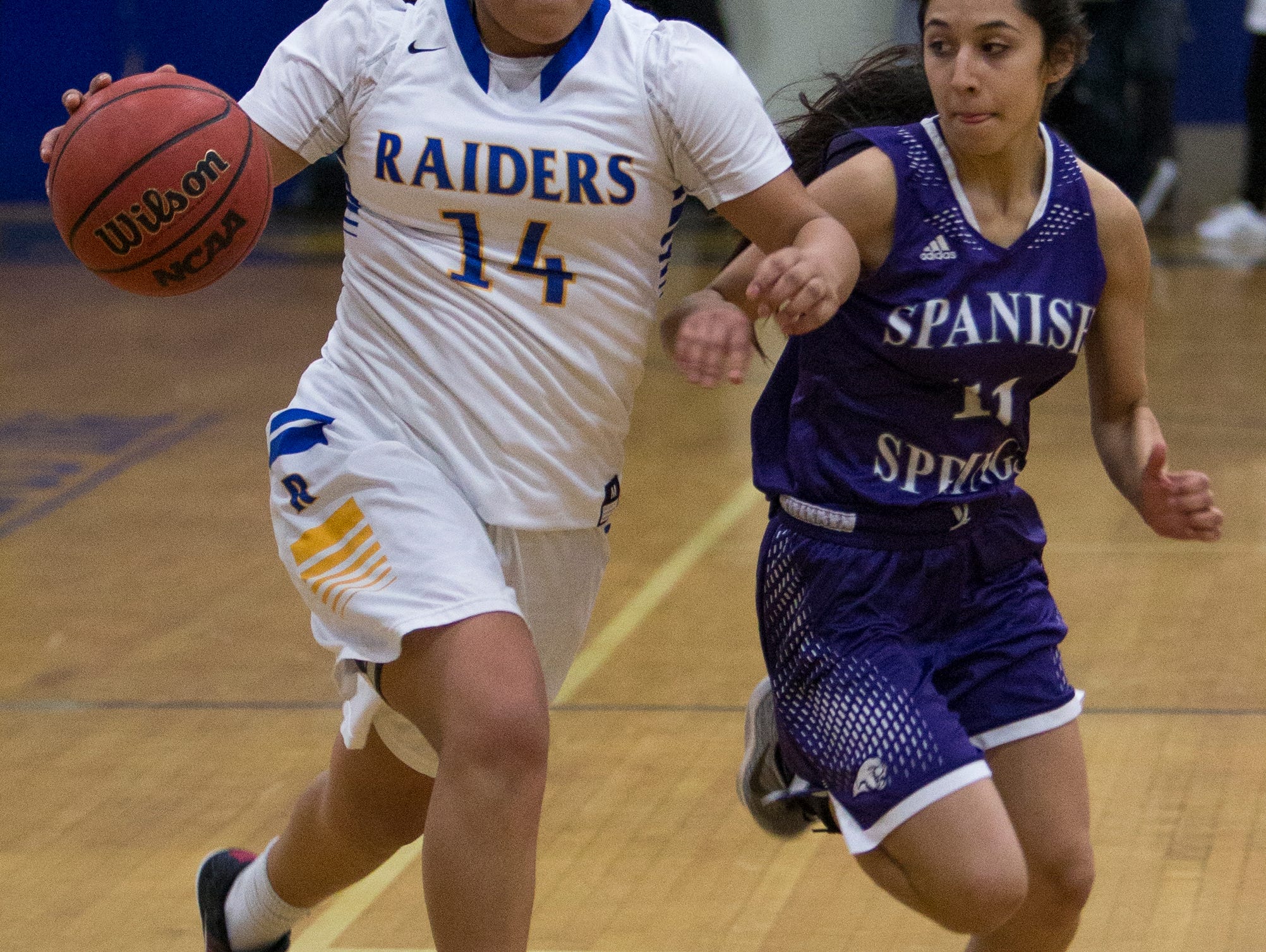 Reed's Autumn Wadsworth drives past Spanish Springs Naelia Pinedo in their basketball game played on Friday night at Reed.