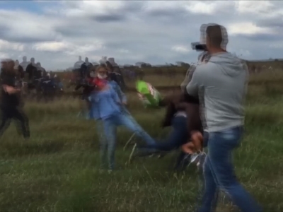 Hungarian journalist filmed tripping man carrying migrant child