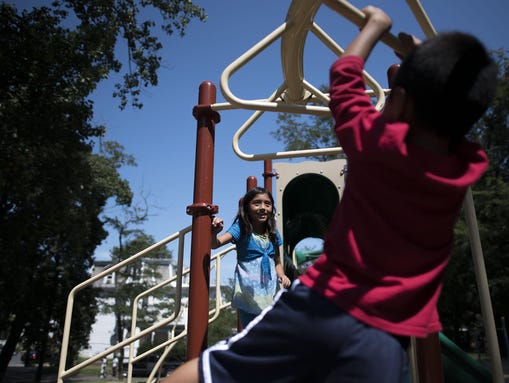 Karen Rodriguez, 8, watches her brother Eric Rodriguez,