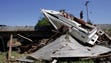 Debris like a boat and a roof  from the flood rest