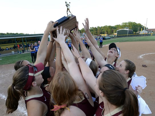 Pittsford Mendon players raise the championship trophy