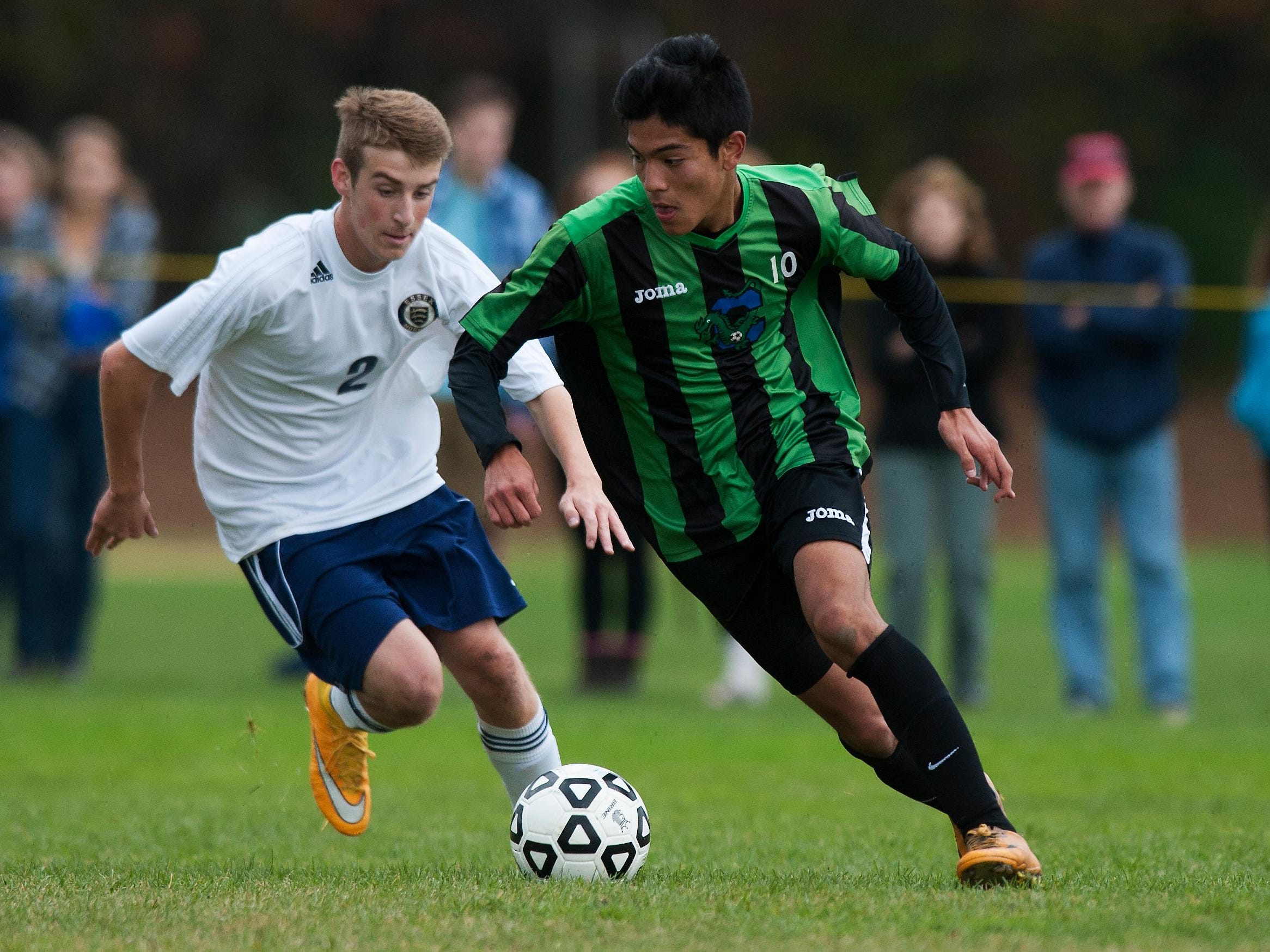 Colchester's Chris Zamarripa (10) runs past Essex's Aidan Whitney (2) with the ball during the boys playoff soccer game between the Colchester Lakers and the Essex Hornets at Essex High School on Saturday afternoon October 25, 2014 in Essex, Vermont (BRIAN JENKINS, for the Free Press)