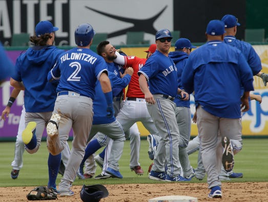 Texas Rangers and Toronto Blue Jays tussle during the