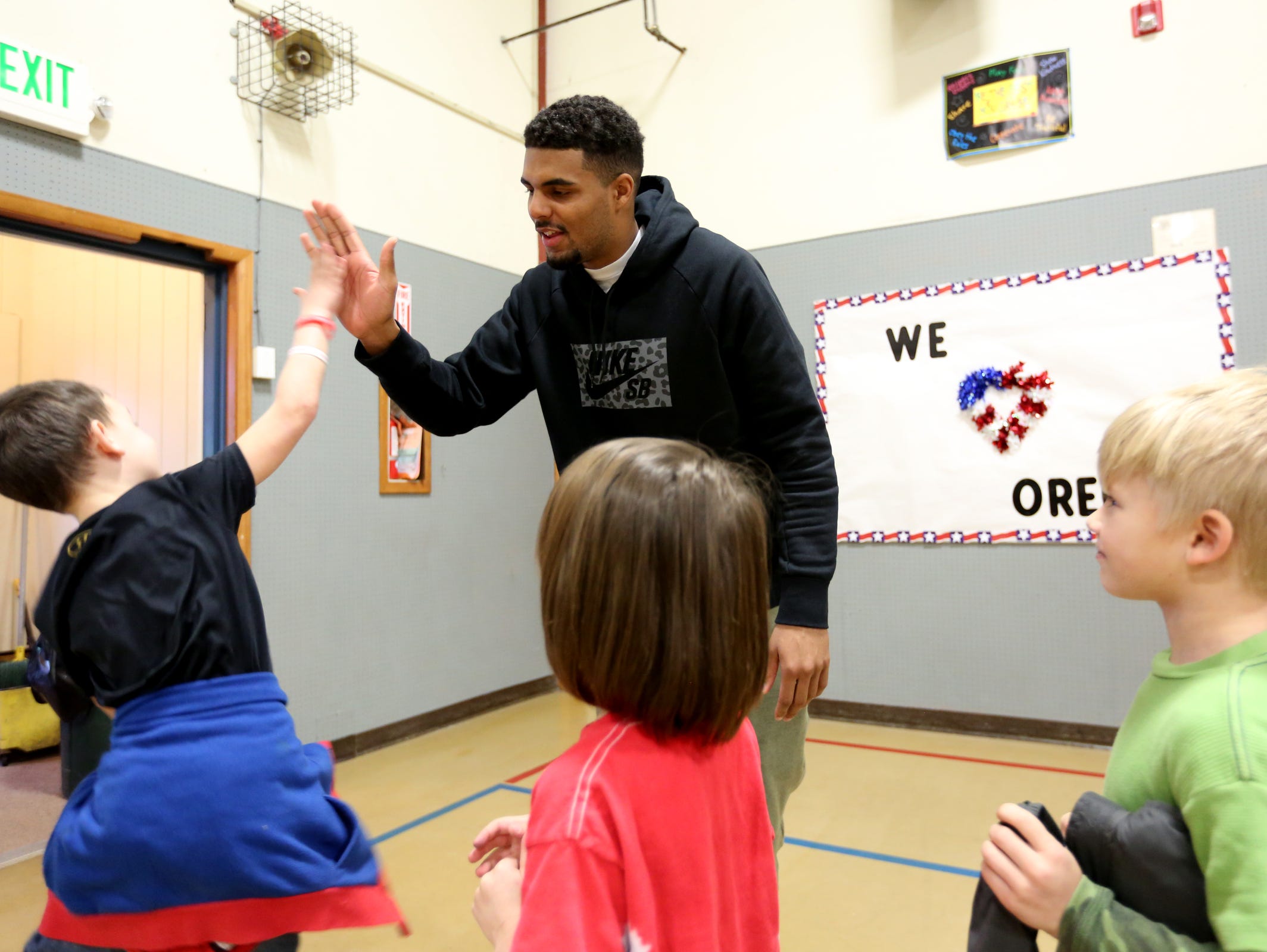 Los Angeles Chargers wide receiver Tyrell Williams high-fives students at Turner Elementary School, where he attended fifth grade, on Tuesday, Feb. 21, 2017.