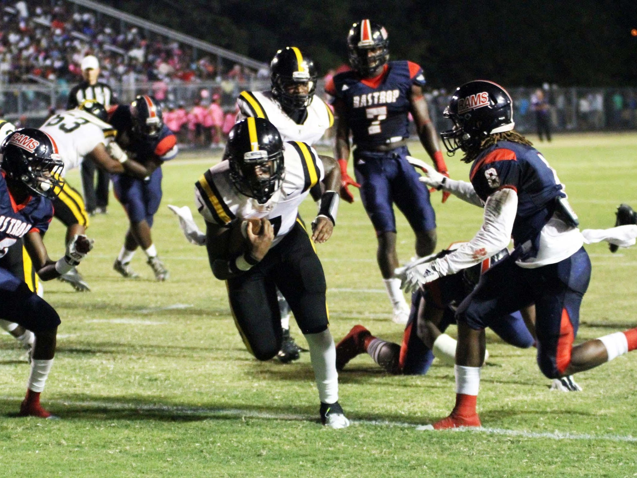 Neville QB Jadien Cole (7) carries the ball in for one of his four touchdowns against the Bastrop Rams Friday night in Bastrop.