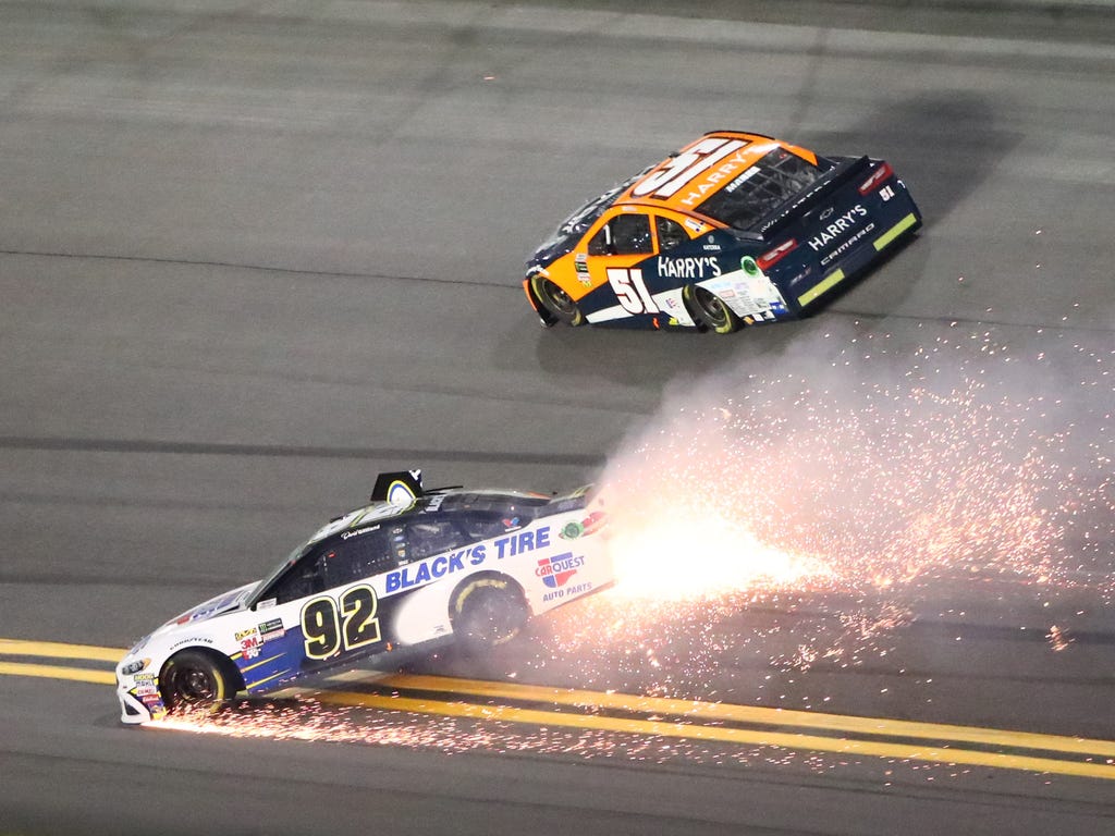 NASCAR driver David Gilliland spins beneath Justin Marks during the Can-Am Duel 1 at Daytona International Speedway in Daytona Beach, Fla.