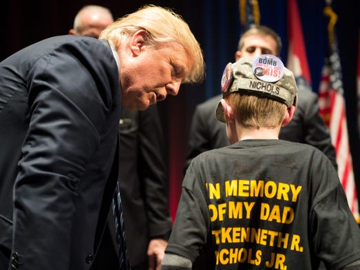 Trump talks to a boy at the end of a rally at the Peabody