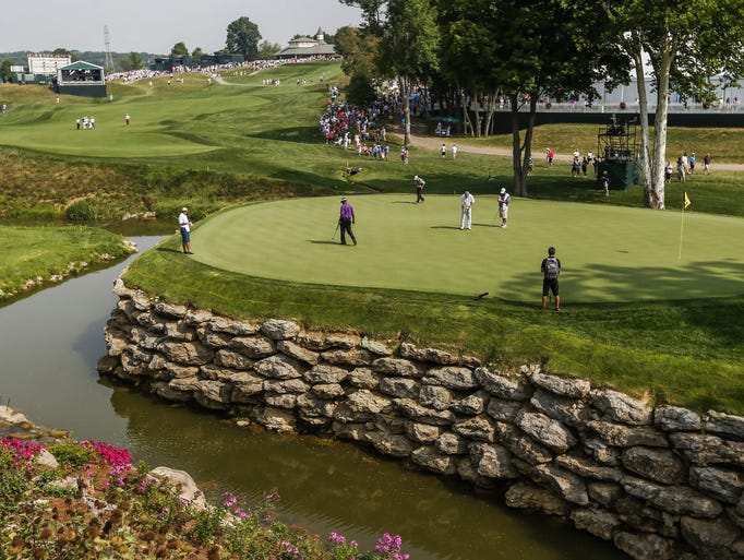 Vijay Singh walks across the thirteenth green as Jason Bohn putts during a practice round at Valhalla Golf Club in Louisville.