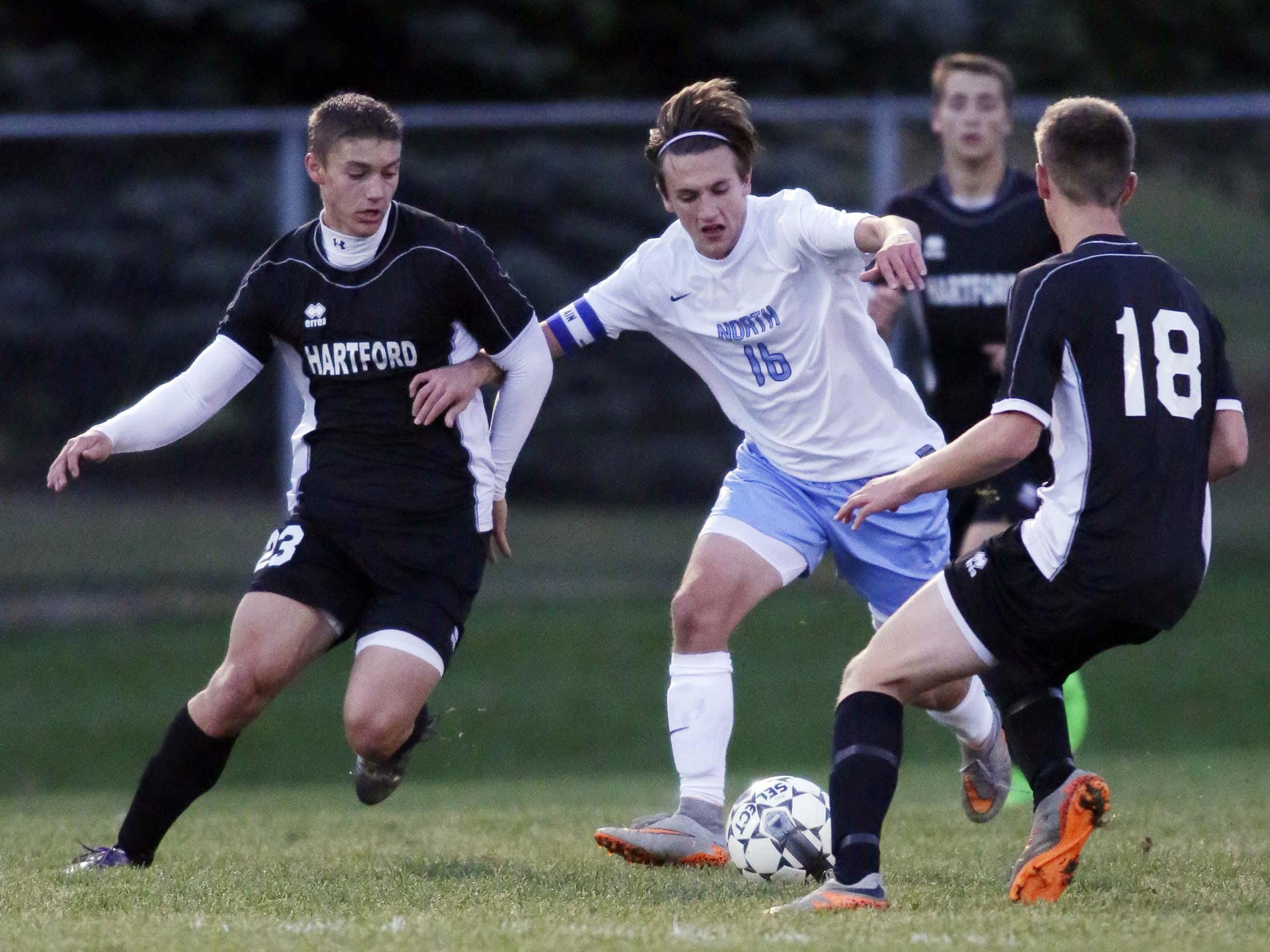 Sheboygan North's Quintin Eisner (16) moves the ball by Hartford players Thursday October 29, 2015 in Sheboygan.