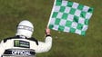 An official waves the green checkered flag to signal