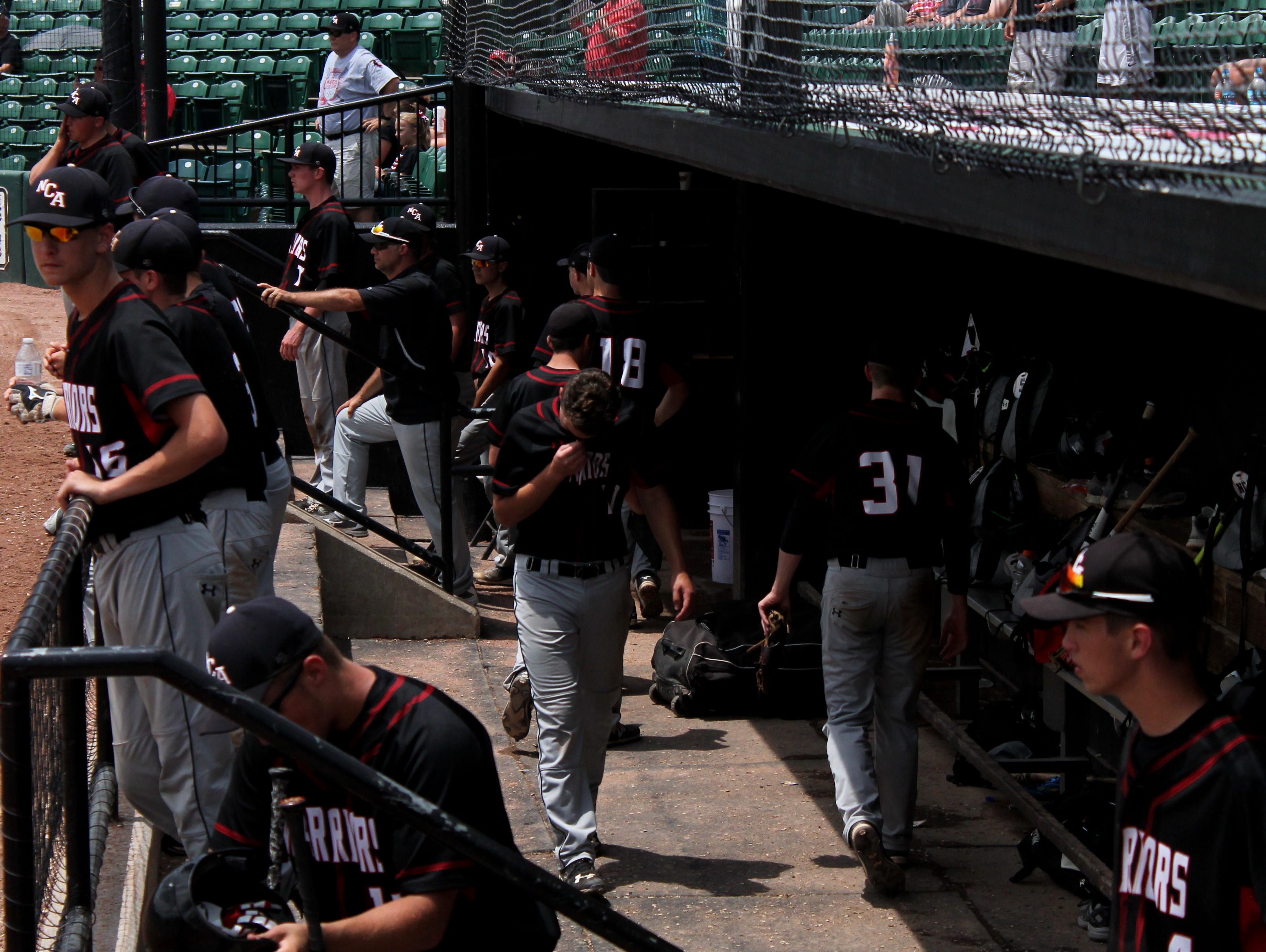New Covenant Academy baseball players react at the end of the 2016 Class 1 state championship game, a 7-2 loss to Bell City in a game played Wednesday, June 1, at CarShield Field in O'Fallon.
