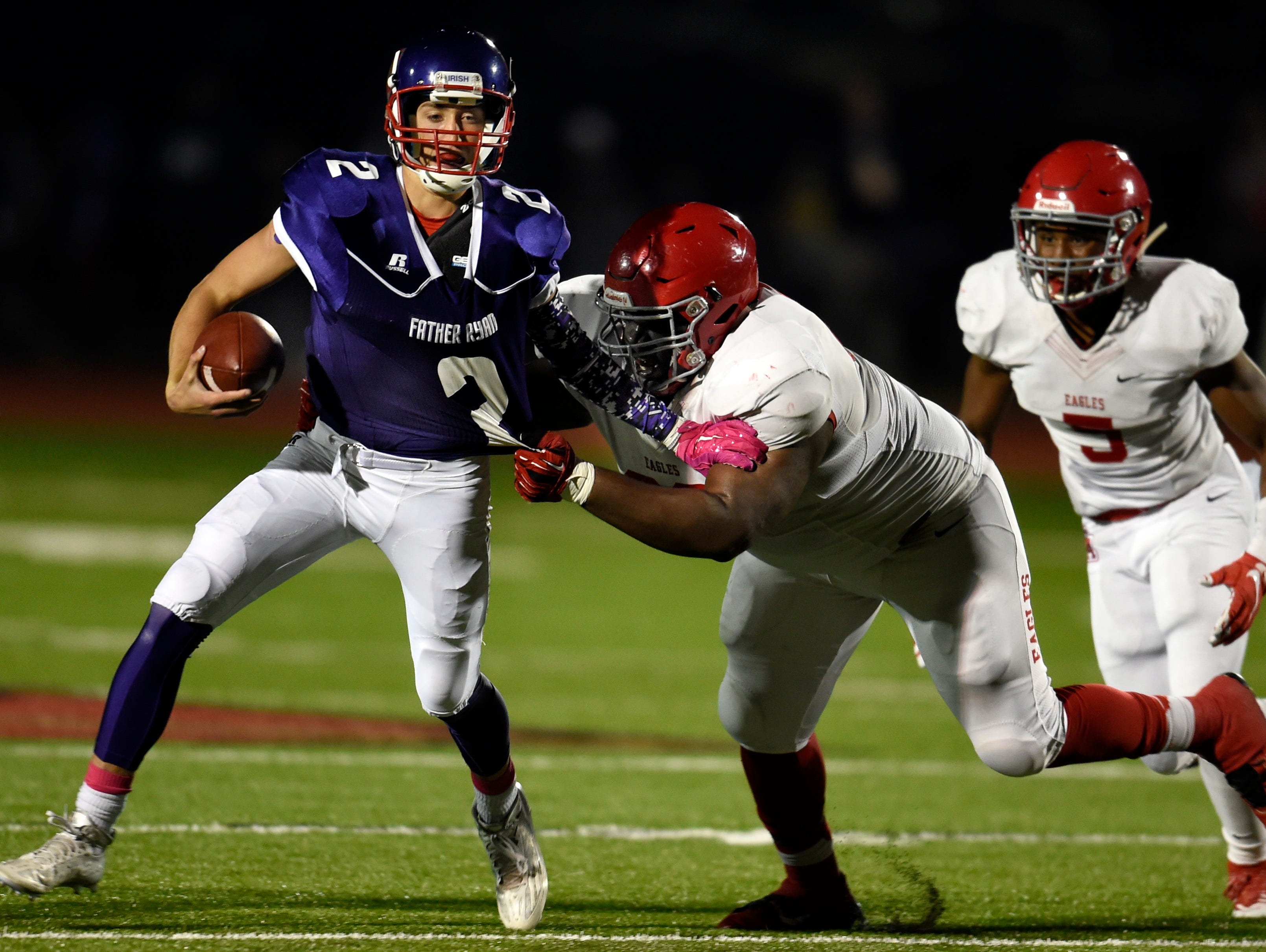 Father Ryan quarterback Zach Pfeifer (2) breaks away from a Brentwood Academy defender during their game Friday.