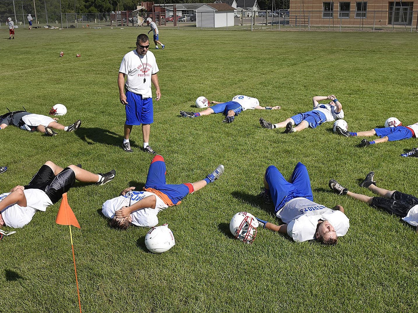 Coach Jay Loven talks to his players while giving them a break during practice Aug. 11 in Swanville.
