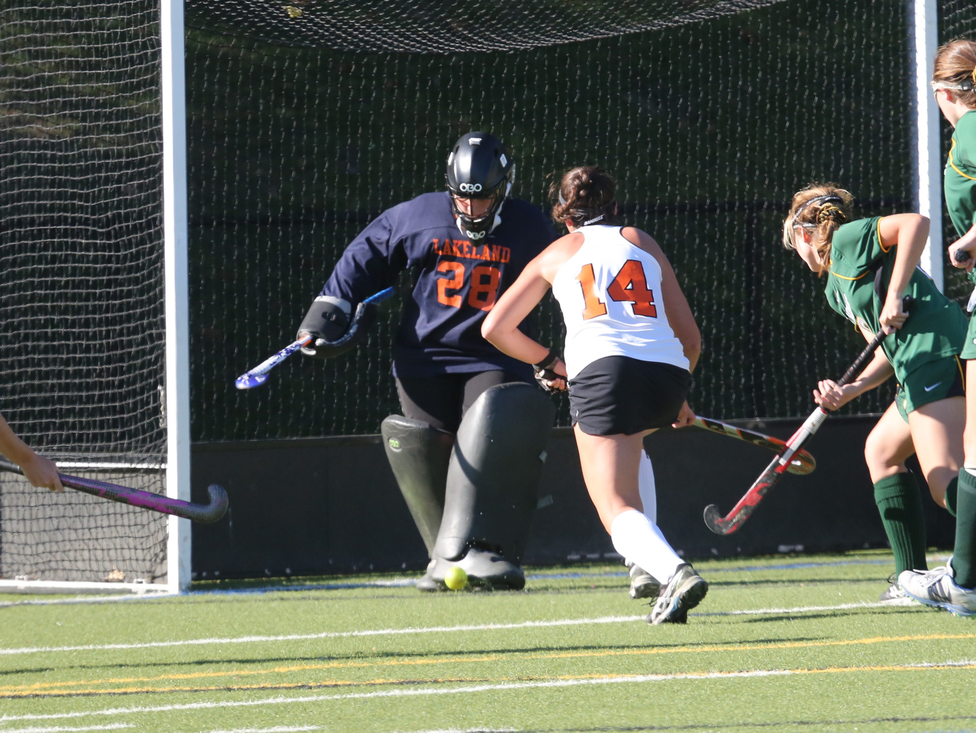 Lakeland goalie Cassie Halpin blocks a shot with Mamaroneck's Sophie Brill bearing down on her during their game at Mamaroneck High School on Saturday.
