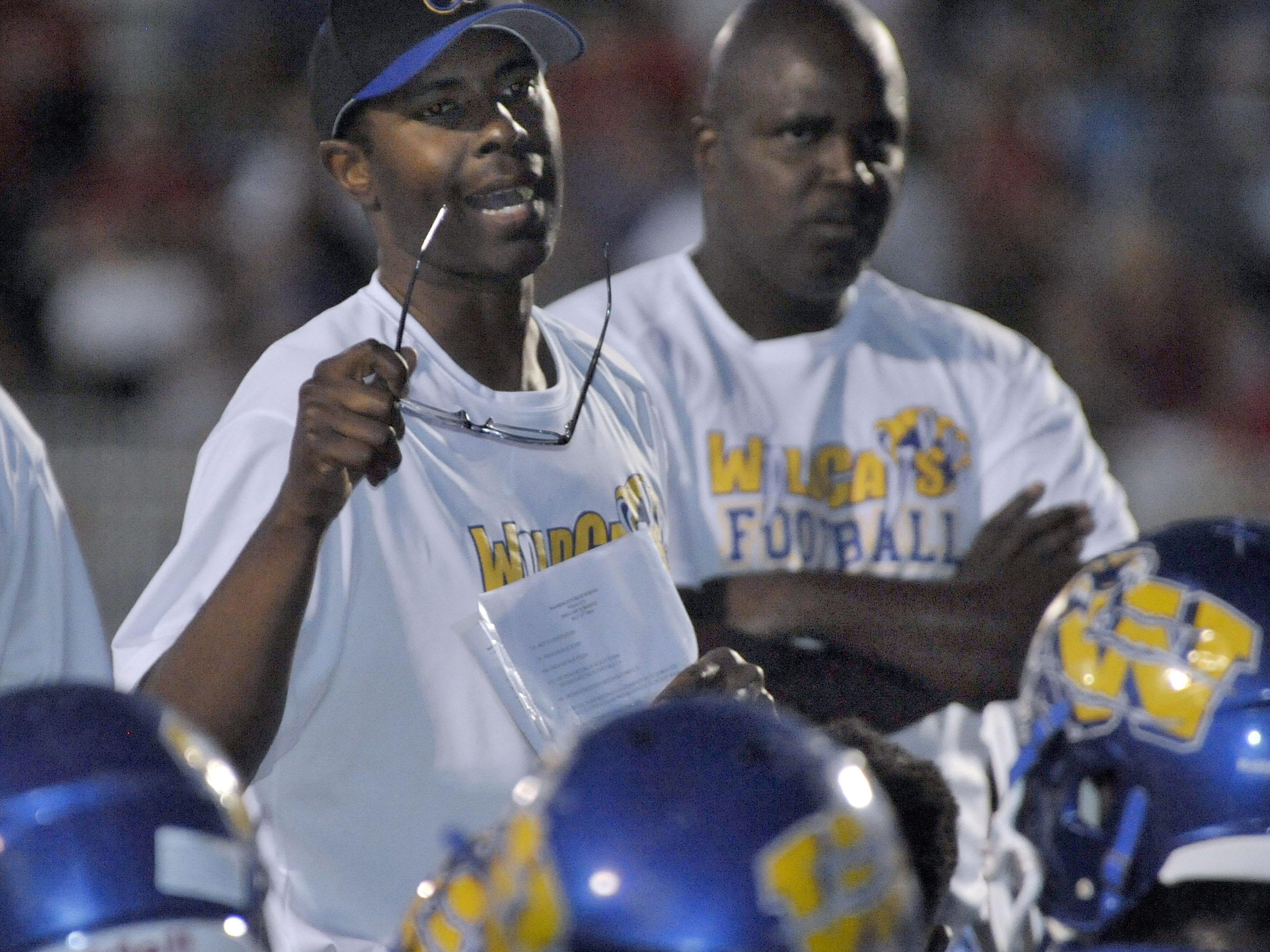 Washington High coach Charlie Ward (holding glasses) will continue his role as Wildcats coach while working with Pensacola Blue Wahoos front office.