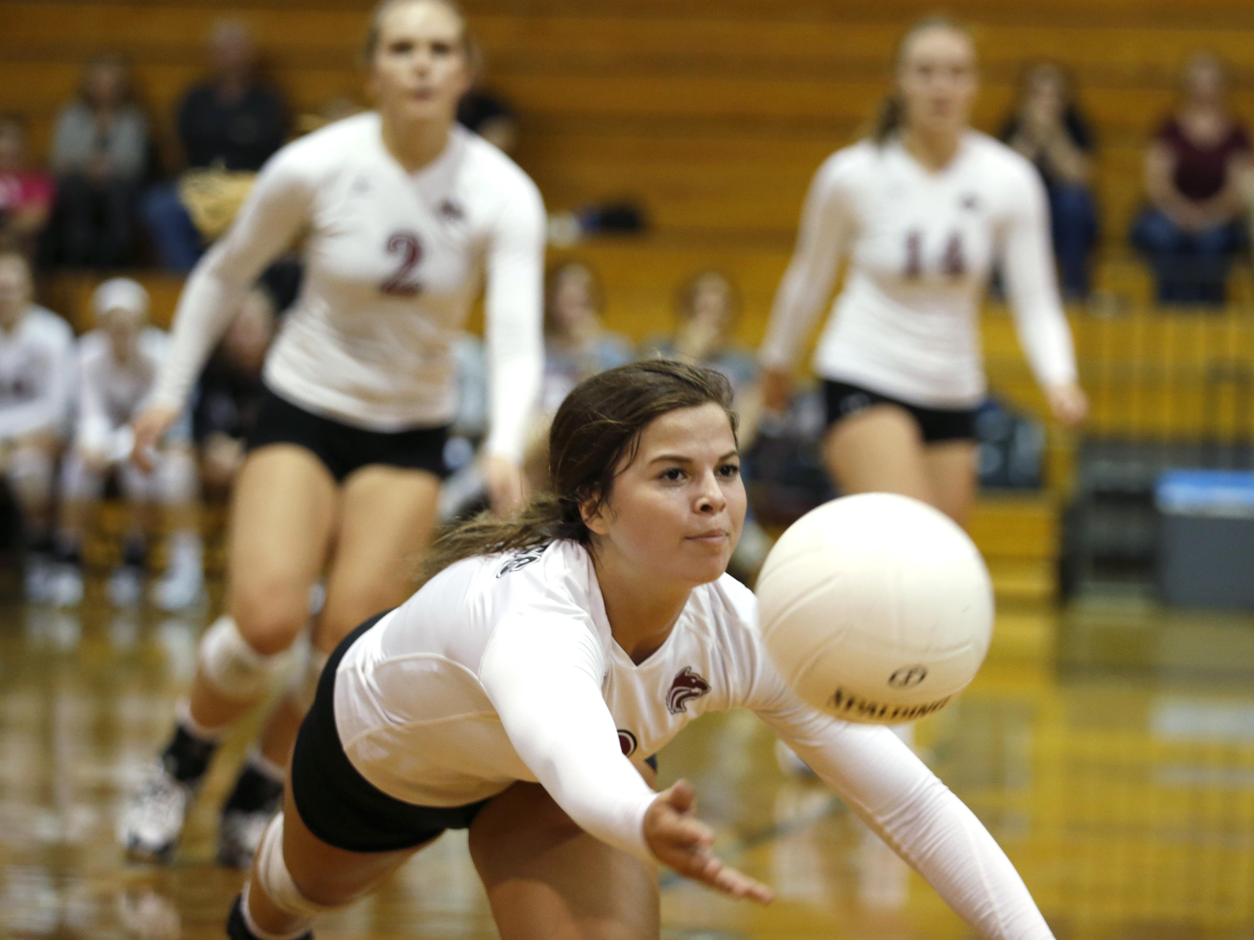 Chiles senior setter Alyssa Rudd dives for a ball during Tuesday’s game against Maclay while teammates Lauren Rizza and Aly Freeland look on. Rudd has 42 assists, while Rizza and Freeland combined for 32 kills and 28 digs as the Timberwolves beat the Marauders, 3-1.
