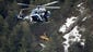 A rescue worker is lifted into an helicopter near the