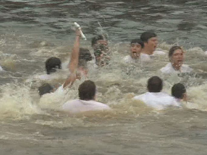 Dozens of young men braved the cold waters for a chance