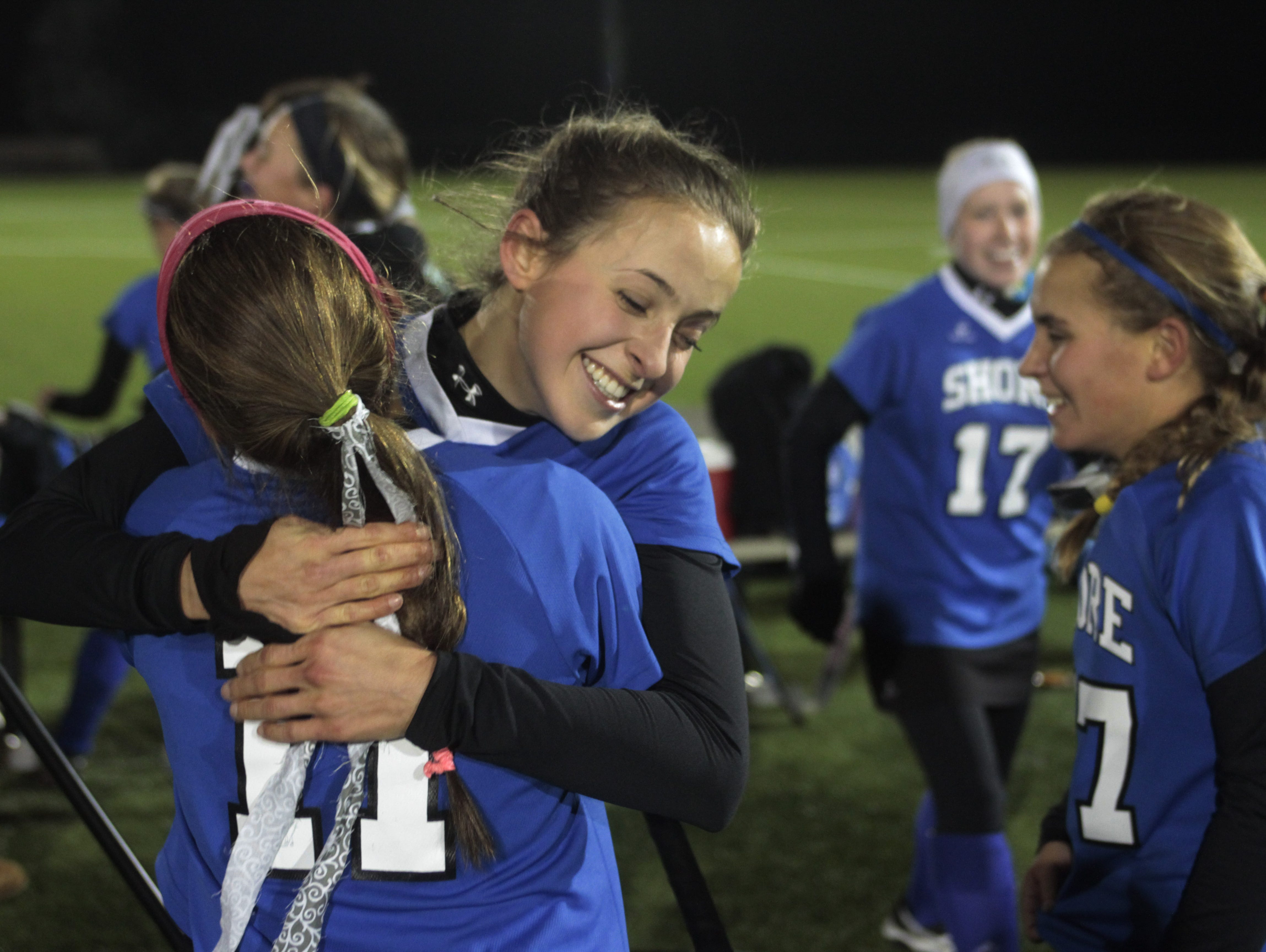 Annie Deusch gets a hug from team mate Veronica Goldberg (facing camera) as they celebtate their group 1 title. Shore Regional vs Collingswood NJSIAA Field Hockey Group I Finals in Bordentown, NJ on November 145, 2014. Peter Ackerman /Staff Photographer