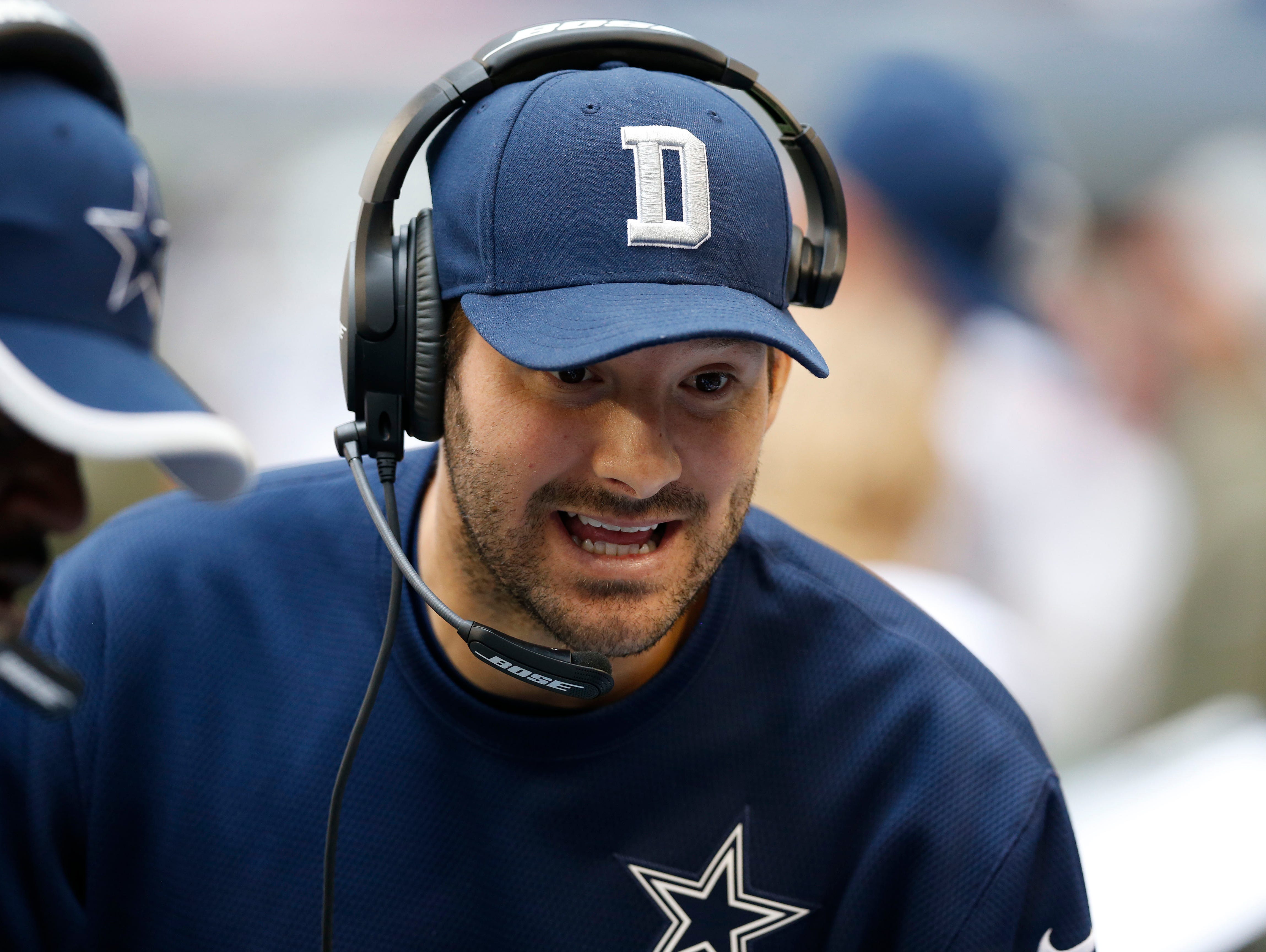 Dallas Cowboys quarterback Tony Romo (9) talks on the sidelines with the offensive players against the Arizona Cardinals at AT&T Stadium.