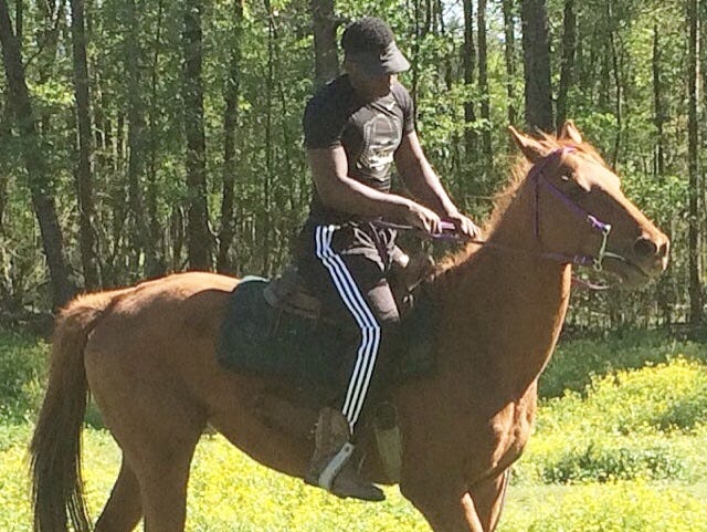 North DeSoto running back Delmonte Hall rides Brown Sugar, his Thoroughbred horse.