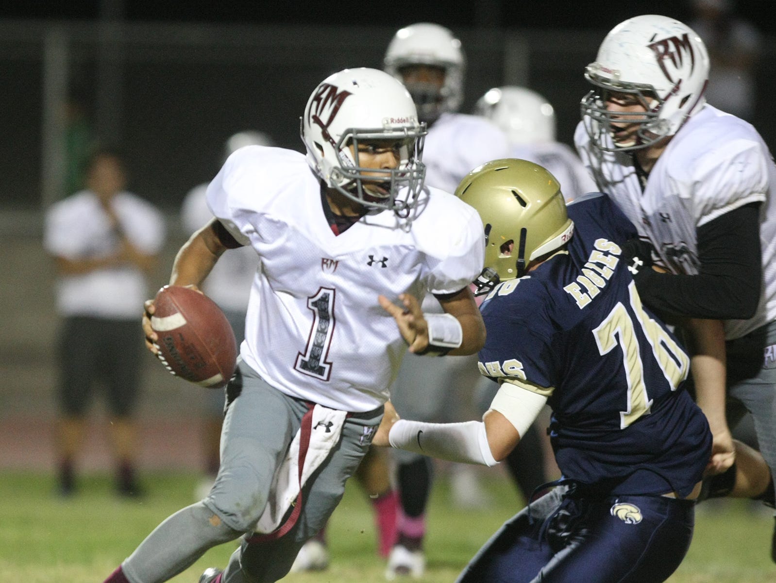 Rancho Mirage QB Marques Prior turns the corner on a scramble during a prep football game between Rancho Mirage and Desert Hot Springs high schools at Desert Hot Springs Thursday , October 9 2014.