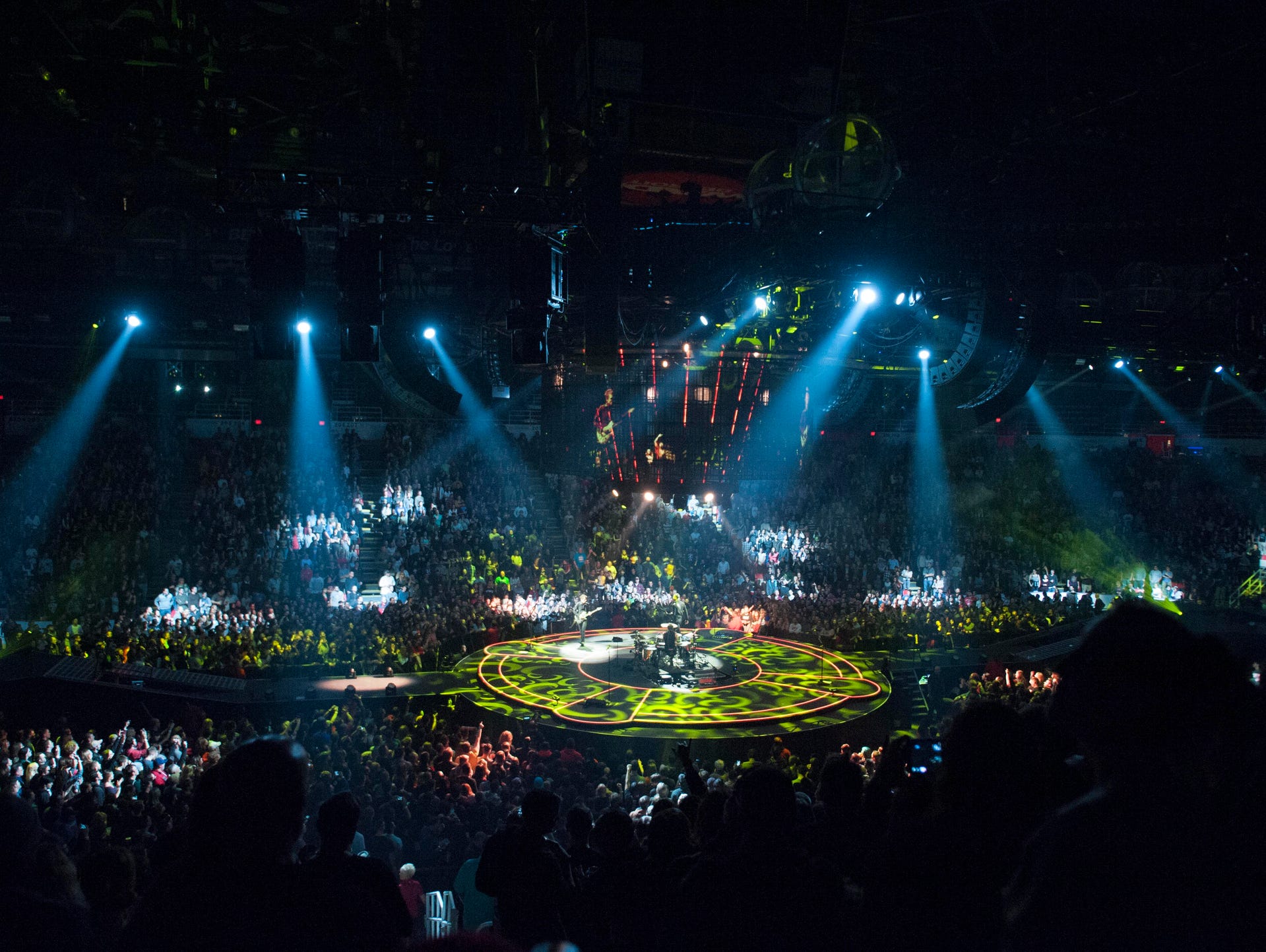 Muse performs on a circular stage in the middle of