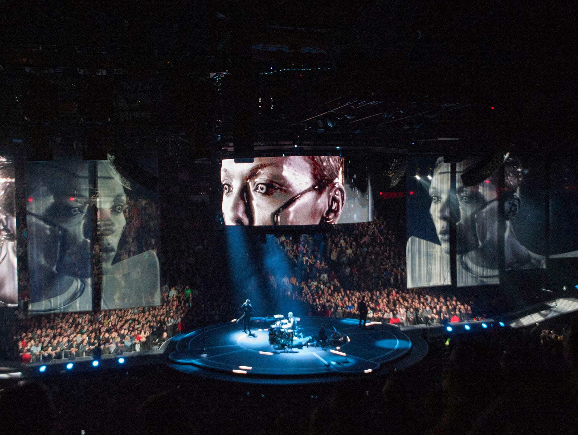 Muse performs on a circular stage in the middle of