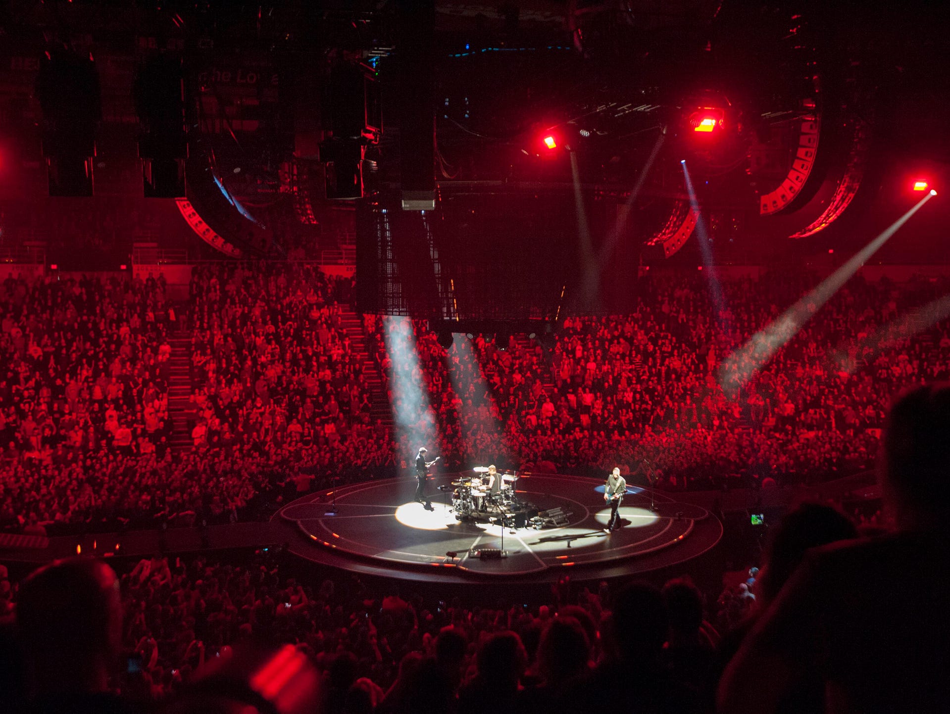 Muse performs on a circular stage in the middle of