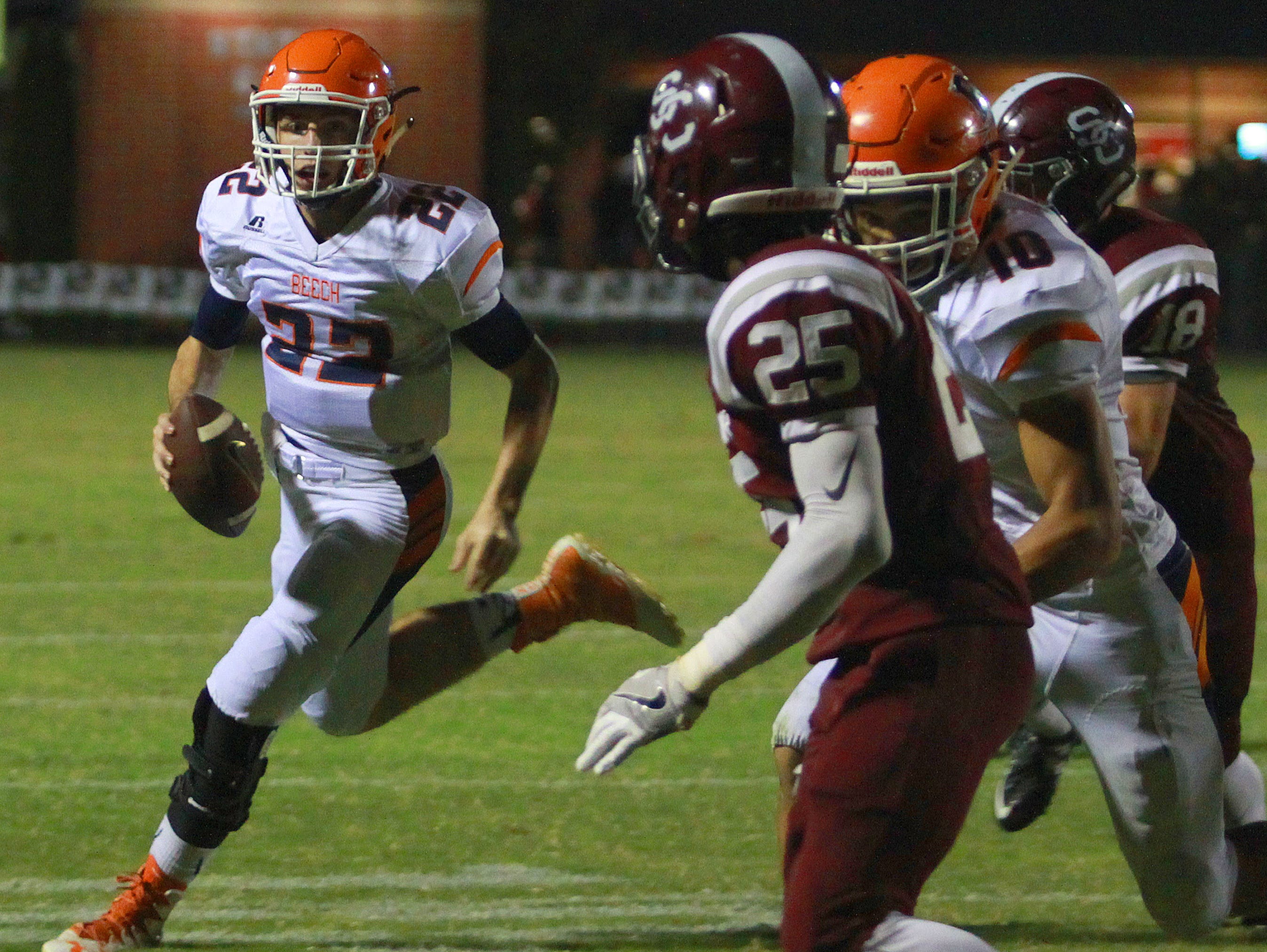 Beech quarterback Nelson Smith looks to scramble as Station Camp's Shawn McKinley closes in during Friday's contest.