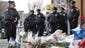 Police officers pay their respects at a makeshift memorial