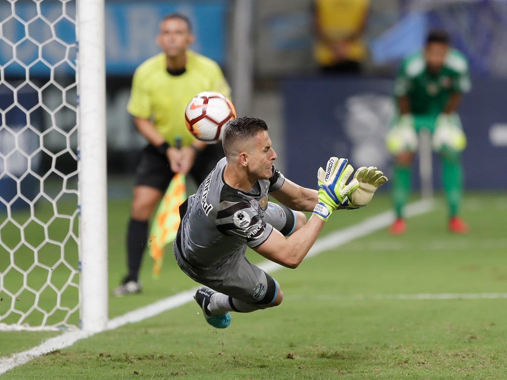 Goalkeeper Marcelo Grohe of Brazil's Gremio makes a save during the penalty shootout at the Recopa Sudamericana final soccer match against Argentina's Independiente in Porto Alegre, Brazil. Gremio won in a penalty shootout after an aggregate 1-1 draw