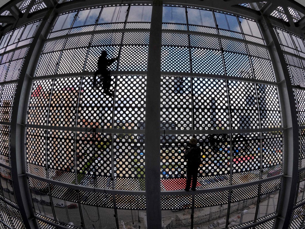 Two construction workers climb on the metal structure of the Yekaterinburg Arena in Russia which will host several football matches of the 2018 FIFA World Cup.