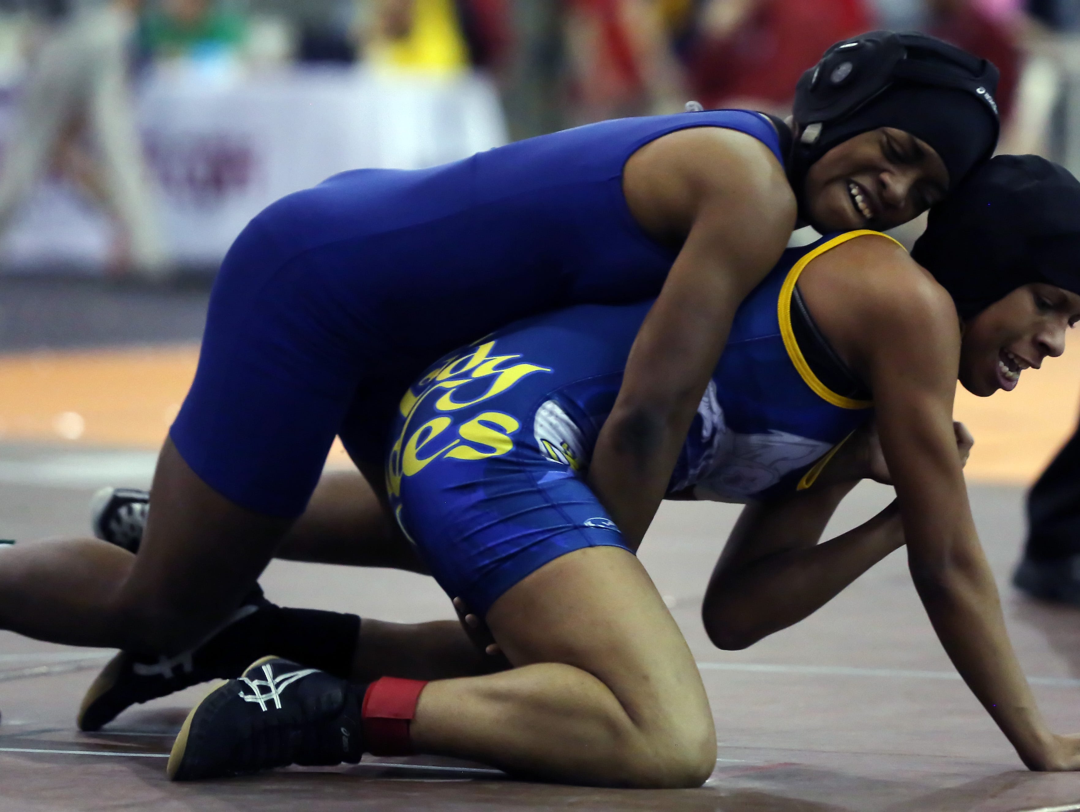 Antioch High School's Shantoia Blackburn, top in blue, wrestles Leilani Birtirrez, bottom in blue and yellow, during the 126-pound semifinals at the TSSAA State Wrestling Tournament Friday.