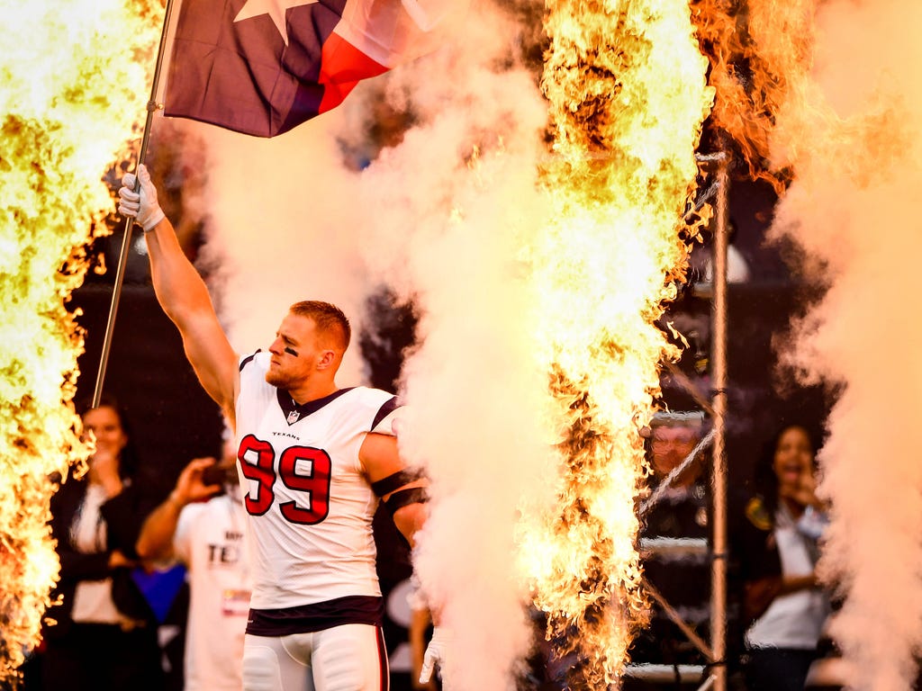 Houston Texans defensive end J.J. Watt waves a Texas state flag during player introductions before the game against the Jacksonville Jaguars at NRG Stadium in Houston.