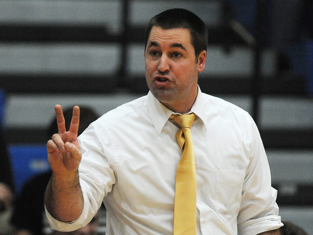 Henryville head coach Jared Hill gives his Hornets instruction as they take on Charlestown on Tuesday at Charlestown High School.