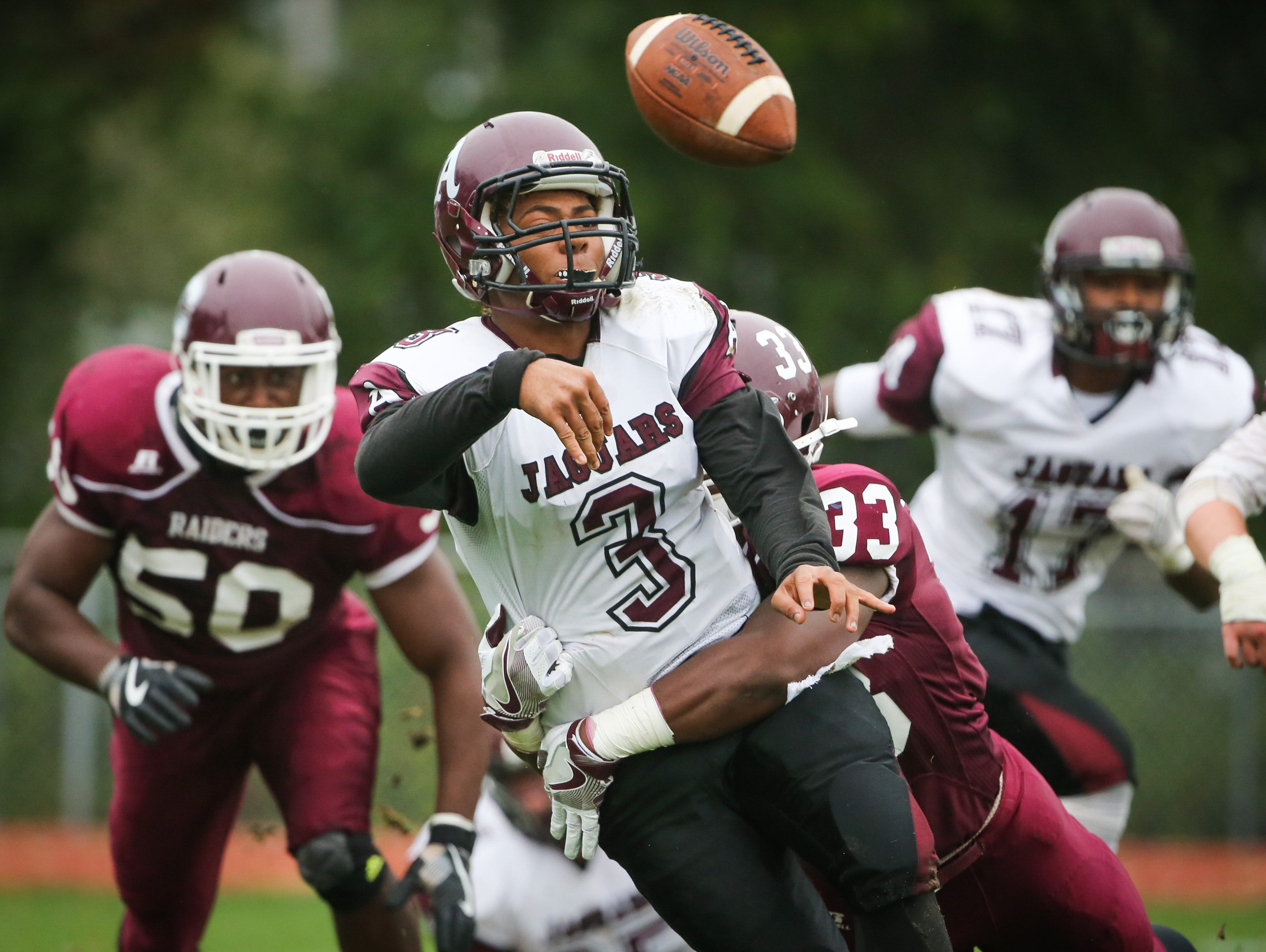 Concord's Byron Simpson hits Appoquinimink quarterback Kenyon Yellowdy as Yellowdy gets rid of the ball. The Raider defense held the Cougars scoreless in a 30-0 win.