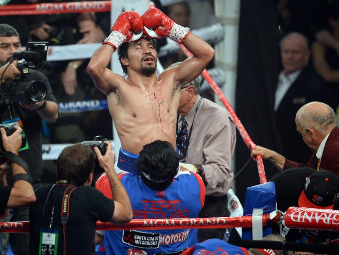 Manny Pacquiao celebrates his victory over Timothy Bradley after their WBO World Welterweight Title bout at MGM Grand Garden Arena.