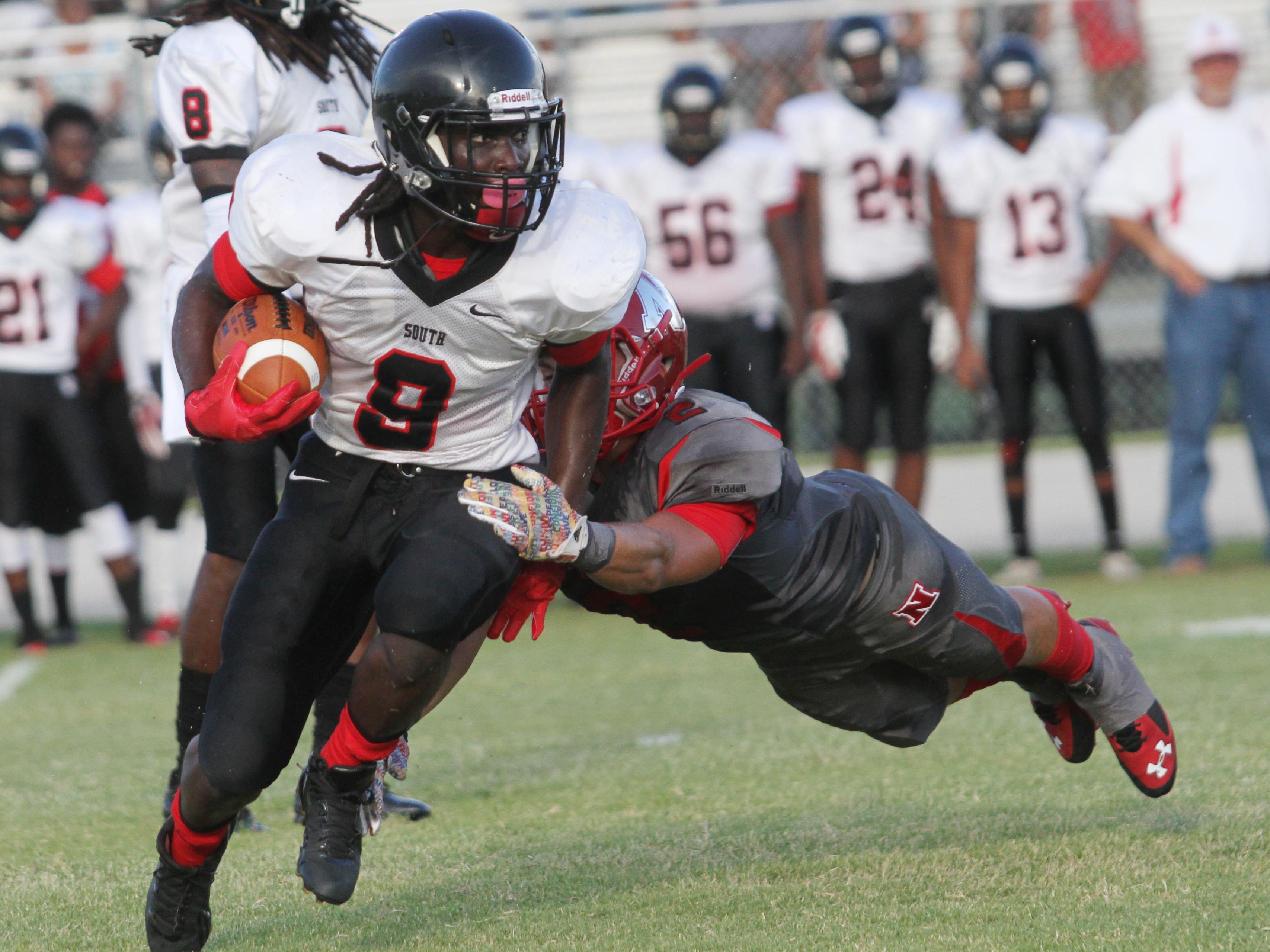 South Fort Myers’ E'Quan Dorris attempts to shake off North Fort Myers defender Zachary St. Amand during a preseason game at North Fort Myers High School on Thursday.